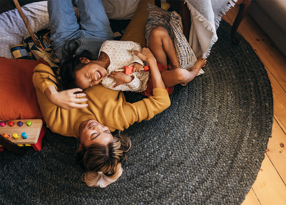 Mother and Daughter Playing on Rug