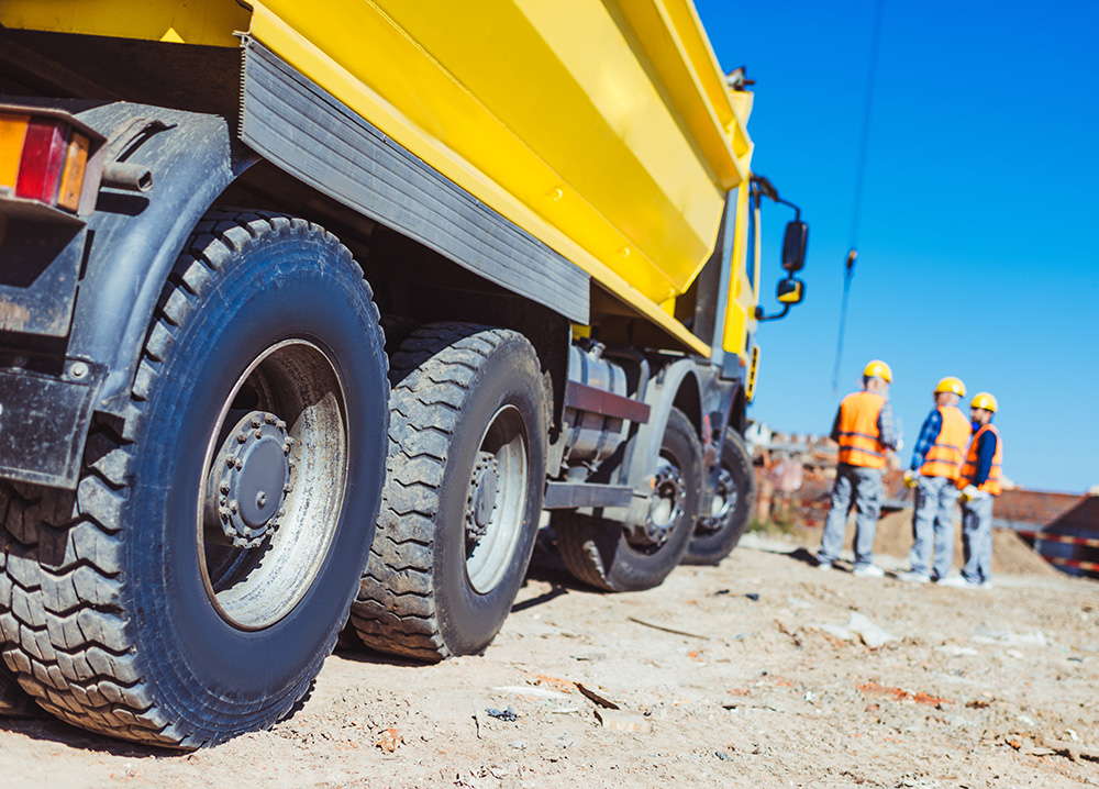 Yellow Dump Truck Near 3 Construction Workers