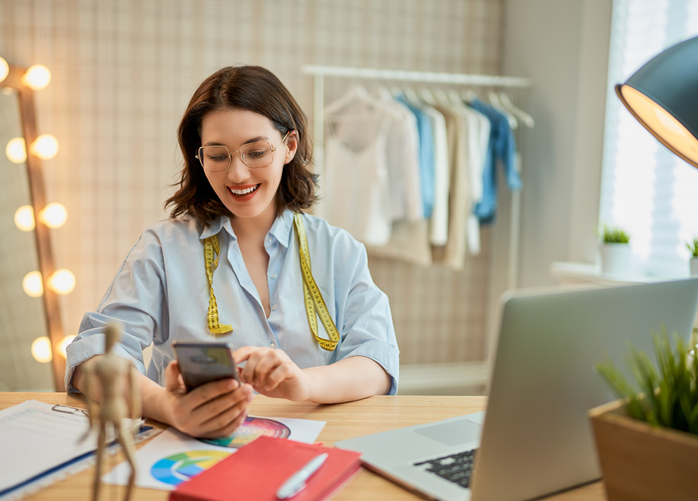 Female Business Owner Looking at Phone