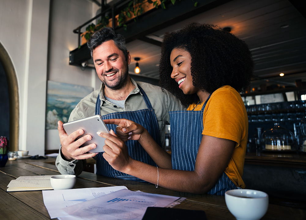 Restaurant Workers Looking at Tablet