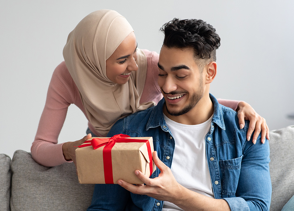 Young Woman Giving Gift to Husband