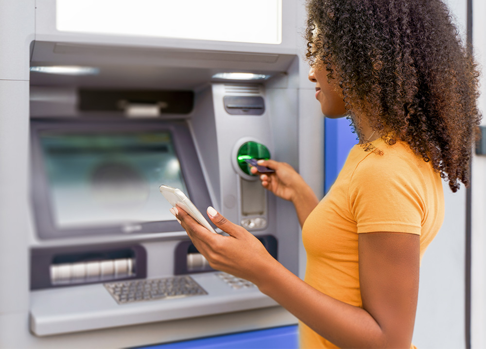 Young Woman Using ATM