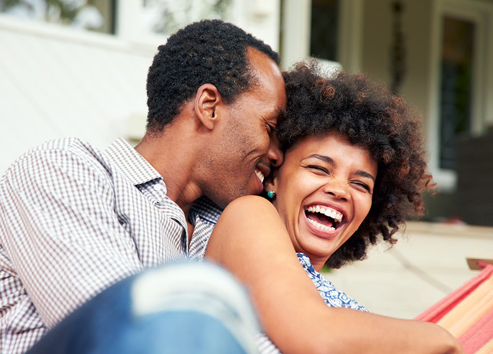 Black Couple Cuddling and Laughing