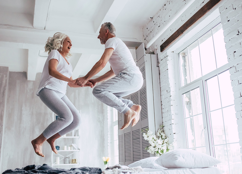 Older Couple Jumping on Bed
