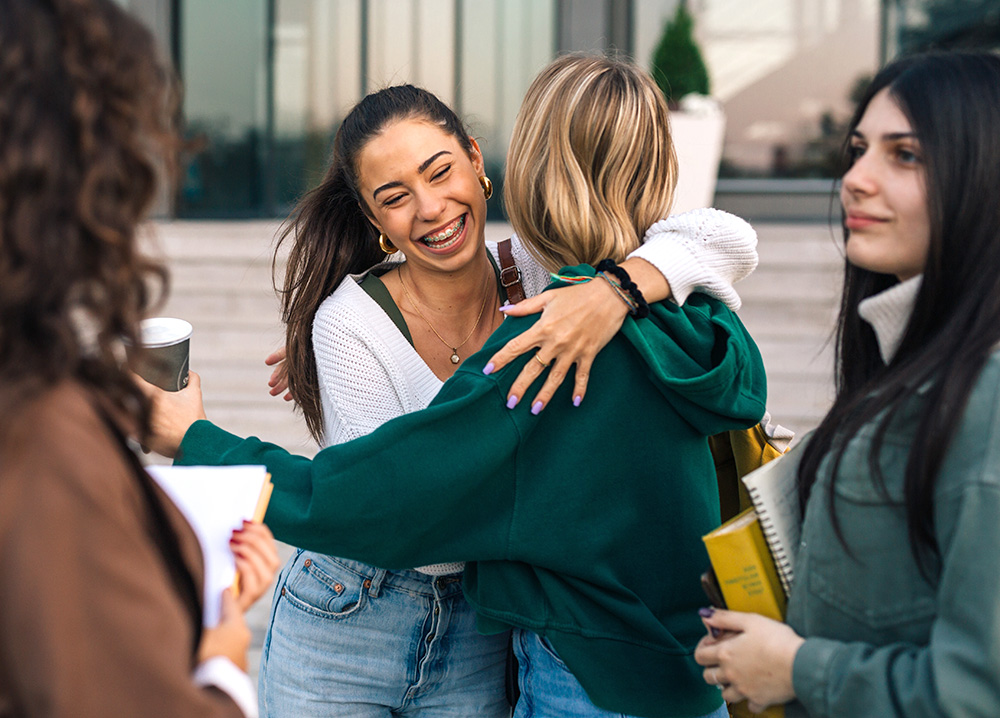 Young Women Hugging to Greet Each Other