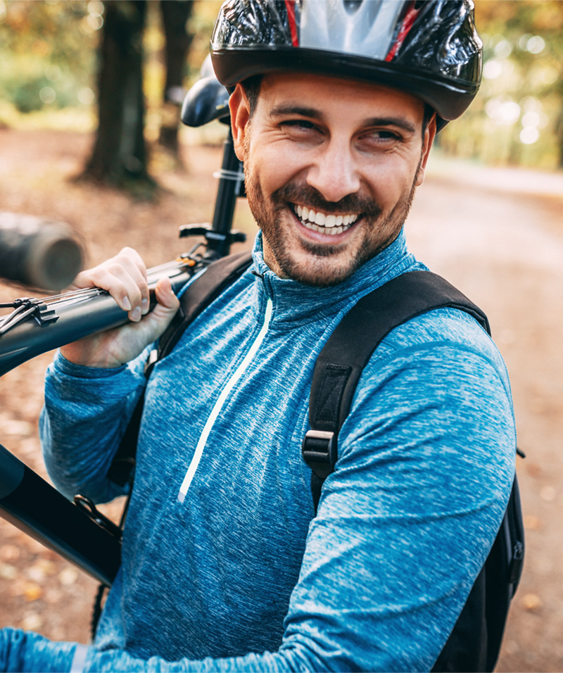 Man Smiling Carrying Bicycle