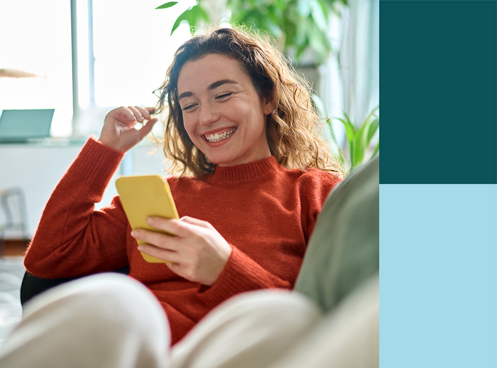 Young Woman Smiling Using Mobile Phone